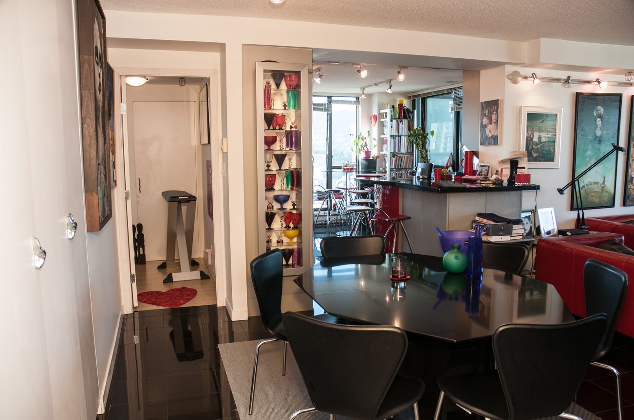 Furnished dining area with modern decor, black chairs, and a glass-top table. - 3201 - 1331 Alberni, Vancouver Downtown
