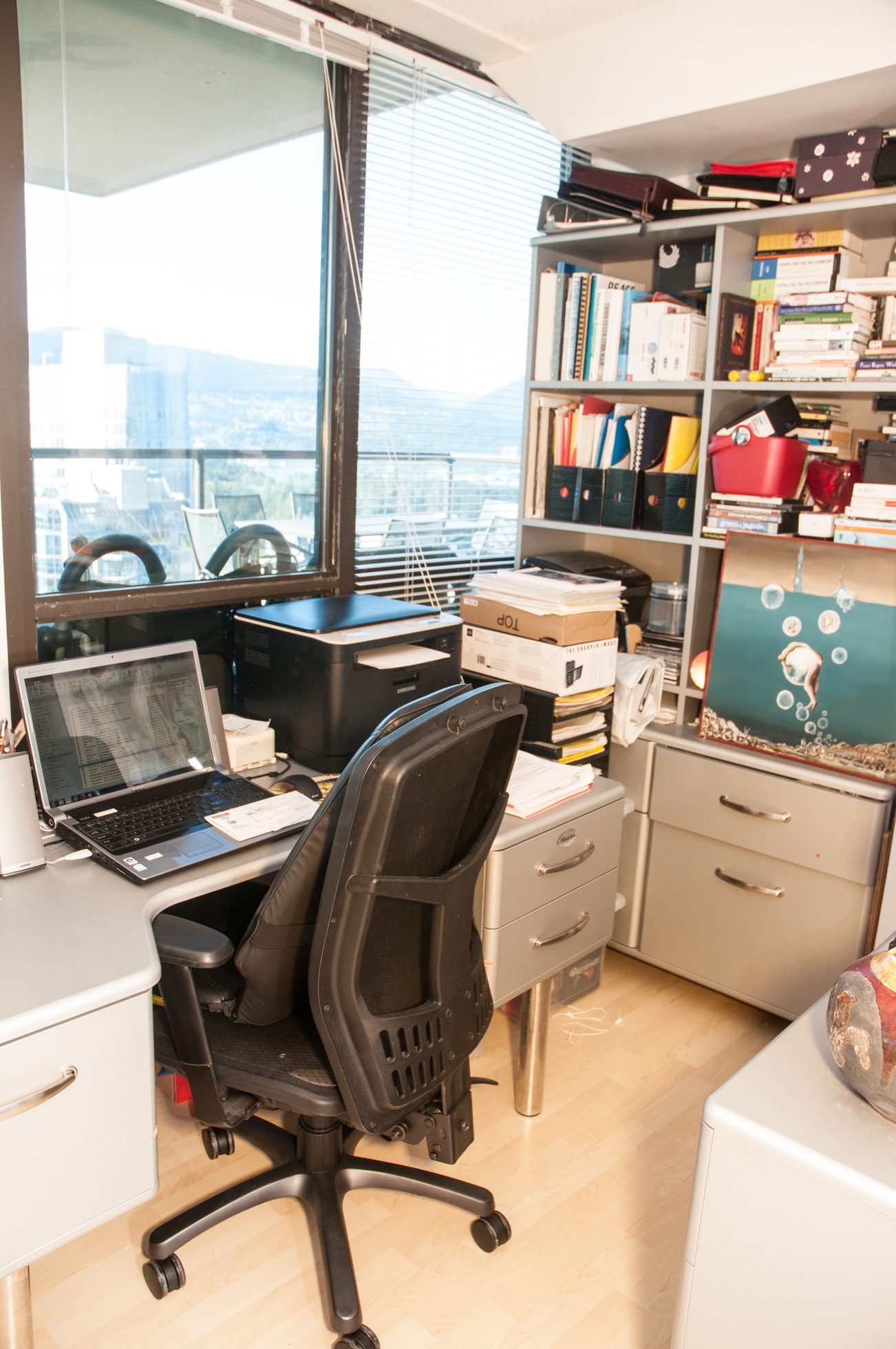 Bright home office with city view, hardwood floors, and a desk with a laptop. - 3201 - 1331 Alberni, Vancouver Downtown