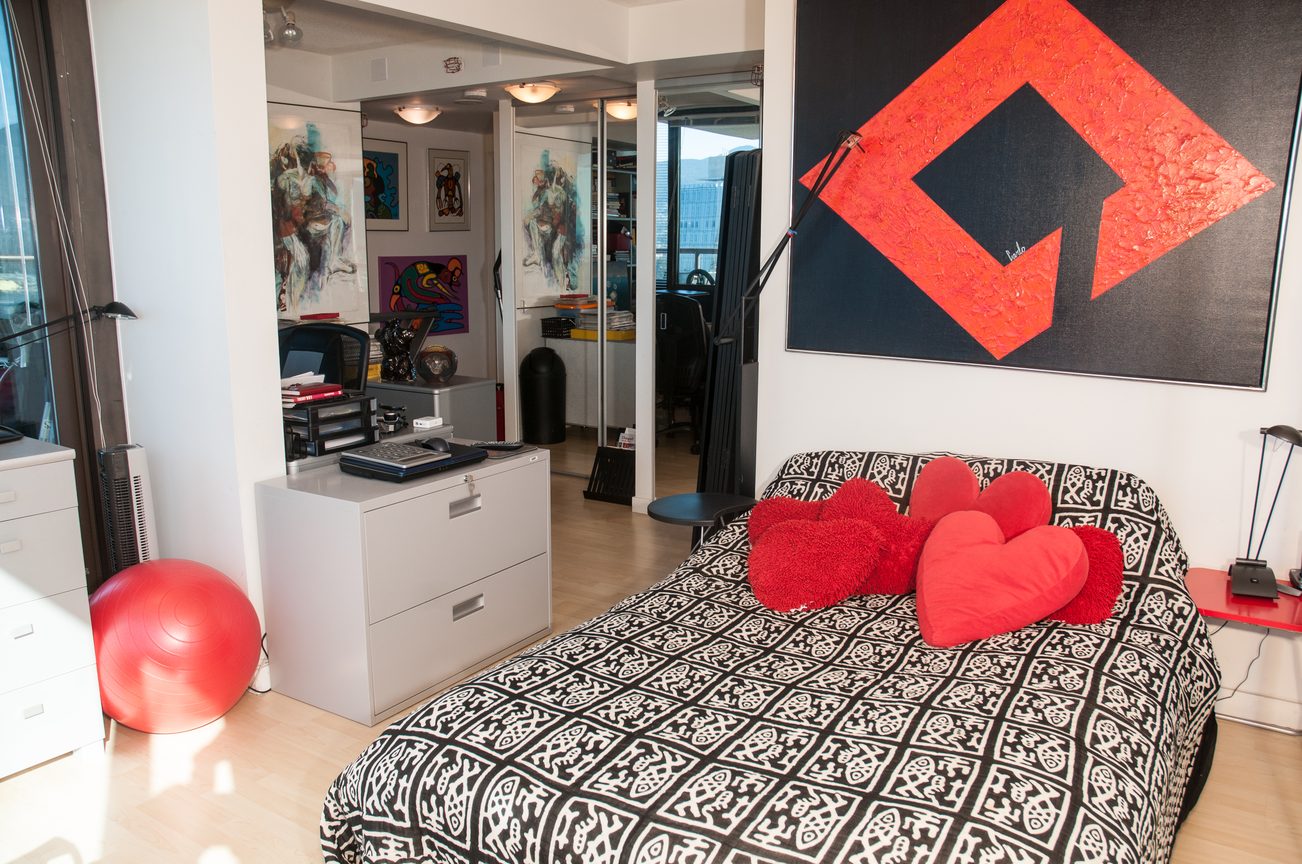 Bright living room with modern decor, red accents, and large artwork. - 3201 - 1331 Alberni, Vancouver Downtown