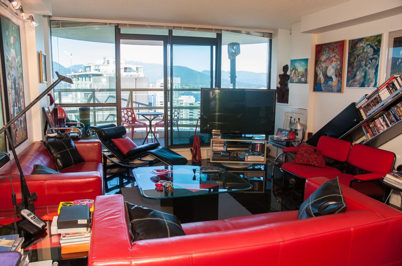 Bright living room with red leather sofas, city view, and modern decor. - 3201 - 1331 Alberni, Vancouver Downtown