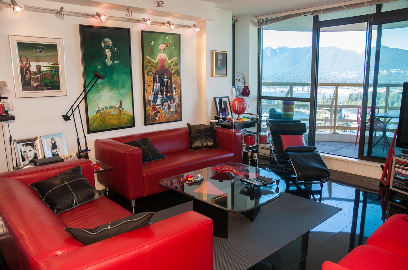Bright living room with red leather furniture, large windows, and city view. - 3201 - 1331 Alberni, Vancouver Downtown