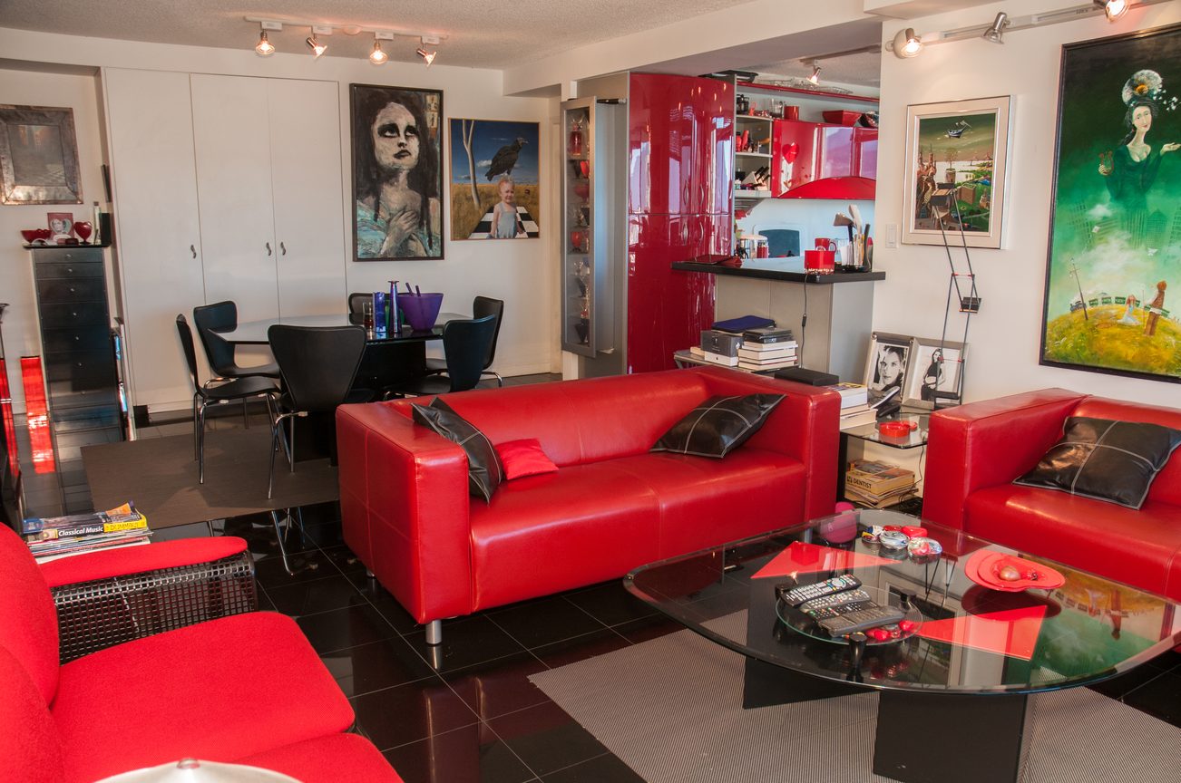 Bright living room with red leather furniture, modern decor, and artwork on the walls. - 3201 - 1331 Alberni, Vancouver Downtown