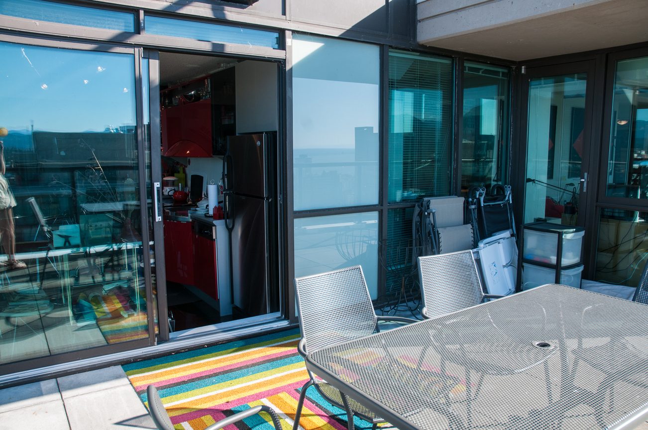 Bright kitchen with stainless steel appliances and city view. - 3201 - 1331 Alberni, Vancouver Downtown