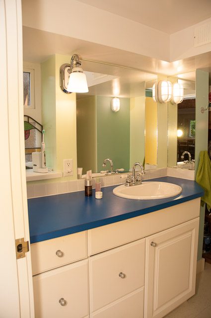 Bathroom with blue countertop and white cabinets, modern light fixtures. - 2885 West 34th Avenue, Vancouver West Side