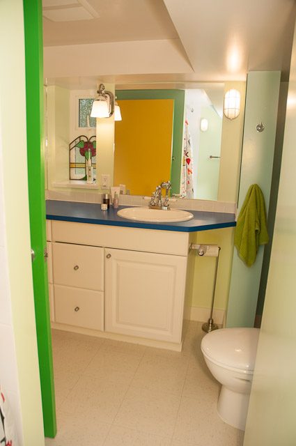 Bright bathroom with blue countertop and green door frame. - 2885 West 34th Avenue, Vancouver West Side
