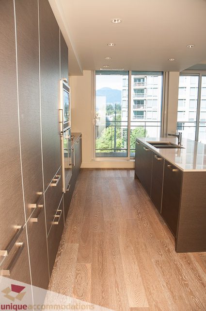 Bright kitchen with modern appliances, hardwood floors, and a city view. - 302 - 1409 W Pender, Vancouver Downtown