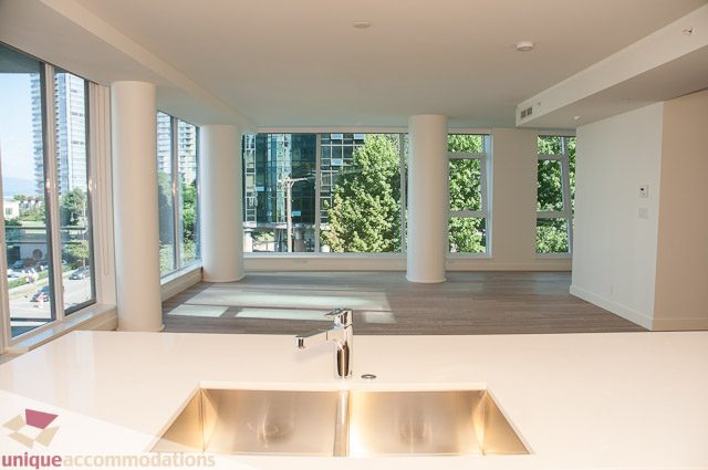 Bright living room with hardwood floors, city view, and large windows. - 302 - 1409 W Pender, Vancouver Downtown