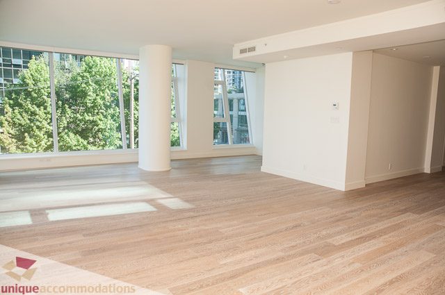 Spacious living room with hardwood floors, large windows, and city view. - 302 - 1409 W Pender, Vancouver Downtown