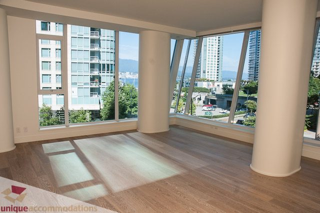 Bright living room with hardwood floors, city view, and large windows. - 302 - 1409 W Pender, Vancouver Downtown