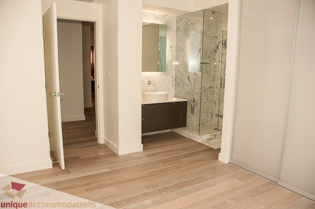 Furnished bathroom with marble countertops and hardwood floors. - 302 - 1409 W Pender, Vancouver Downtown