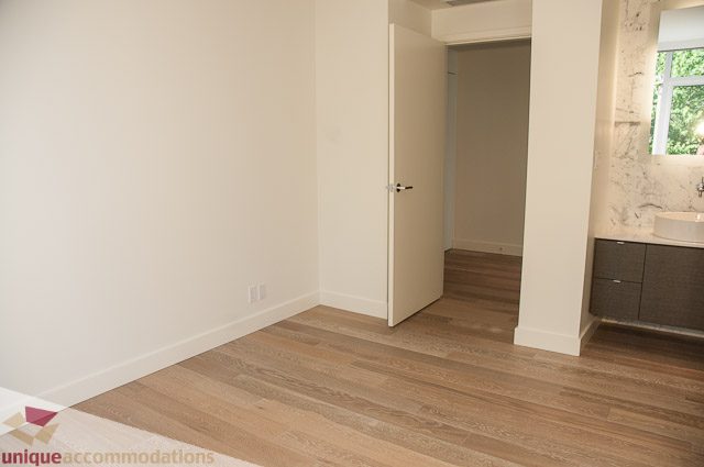 Bright den with hardwood floors, white walls, and a partial view of a bathroom. - 302 - 1409 W Pender, Vancouver Downtown