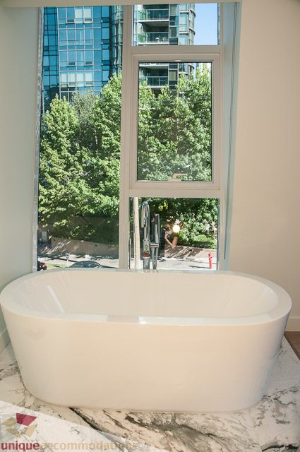 Bright bathroom with marble countertops and a city view. - 302 - 1409 W Pender, Vancouver Downtown