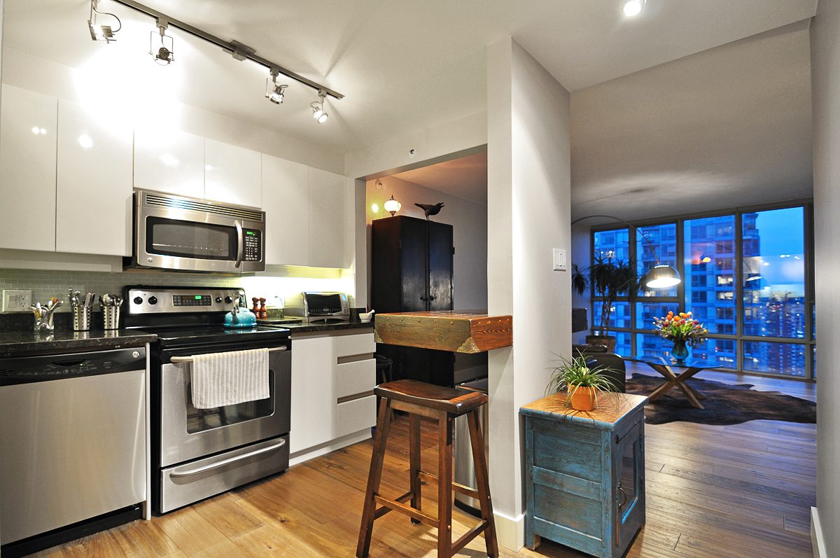 Bright kitchen with modern appliances, hardwood floors, and a city view. - 2702 - 930 Cambie Street, Vancouver Downtown