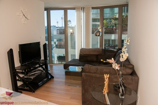 Furnished living room with hardwood floors, city view, and modern decor. - 604-1000 Beach Avenue, Vancouver Downtown