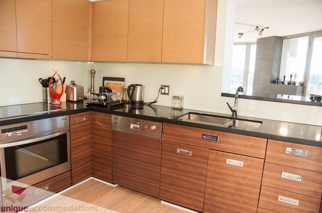 Bright kitchen with modern wood cabinets, stainless steel appliances, and a city view. - 604-1000 Beach Avenue, Vancouver Downtown