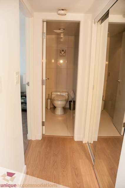 Bright bathroom with wooden flooring and a modern toilet. - 604-1000 Beach Avenue, Vancouver Downtown