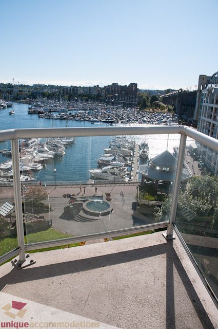 Balcony with glass rail, city view, marina, and fountain. - 604-1000 Beach Avenue, Vancouver Downtown