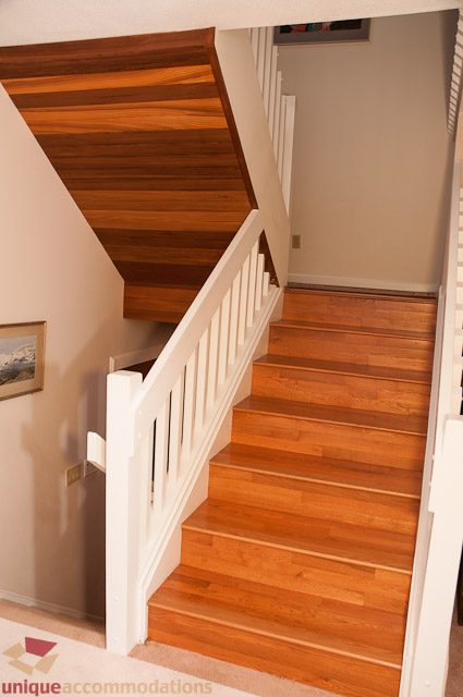 Staircase with wooden steps and white railings leading to upper level. - 4559 W. 3rd Ave, Vancouver West Side