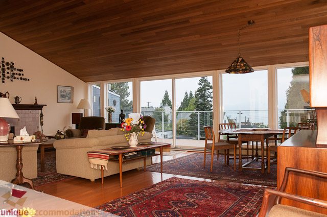 Spacious living room with hardwood floors, large windows, and a city view. - 4559 W. 3rd Ave, Vancouver West Side