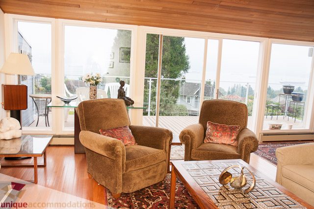 Bright living room with large windows, hardwood floors, and a city view. - 4559 W. 3rd Ave, Vancouver West Side