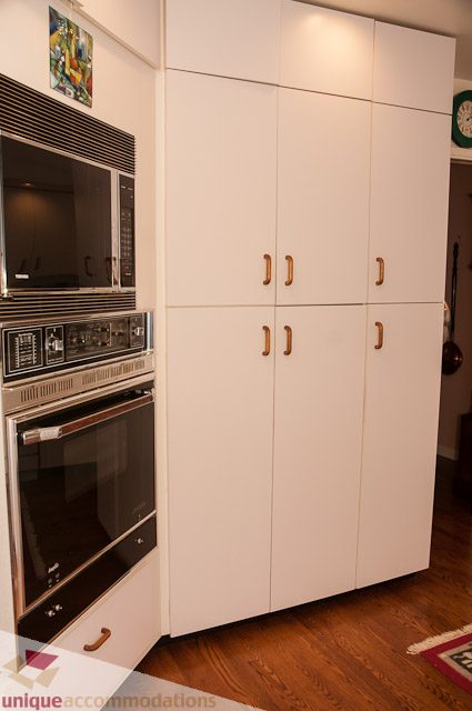 Bright kitchen with white cabinetry, stainless steel appliances, and hardwood floors. - 4559 W. 3rd Ave, Vancouver West Side
