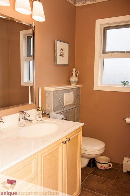 Bathroom with beige countertops, decorative tile backsplash, and a window with frosted glass. - 4559 W. 3rd Ave, Vancouver West Side