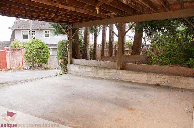 Covered patio with wooden beams and concrete flooring. - 4559 W. 3rd Ave, Vancouver West Side