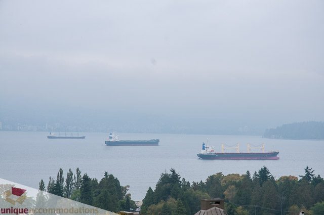 Furnished living room with a stunning city view of ships and water. - 4559 W. 3rd Ave, Vancouver West Side