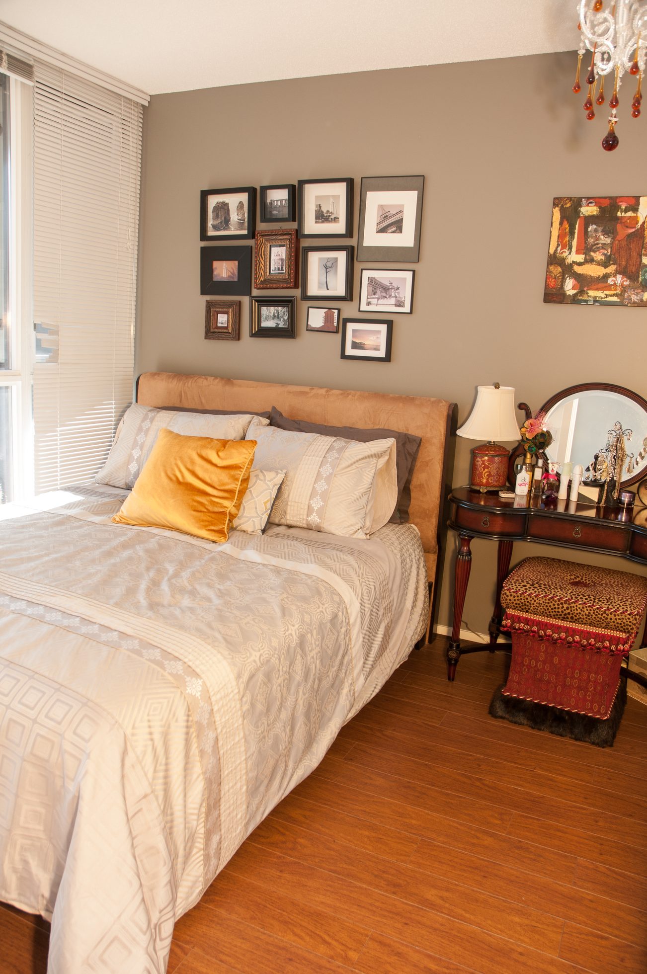 Furnished 1-bedroom condo with hardwood floors, cozy bedding, and a gallery wall of framed photos. - 1405-1155 Seymour Street, Vancouver Downtown