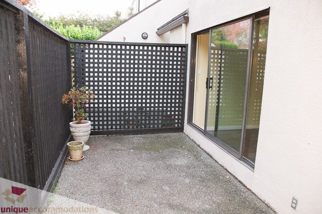 Furnished patio with black lattice fence and potted plants. - 3 - 1786 Esquimalt Avenue, West Vancouver