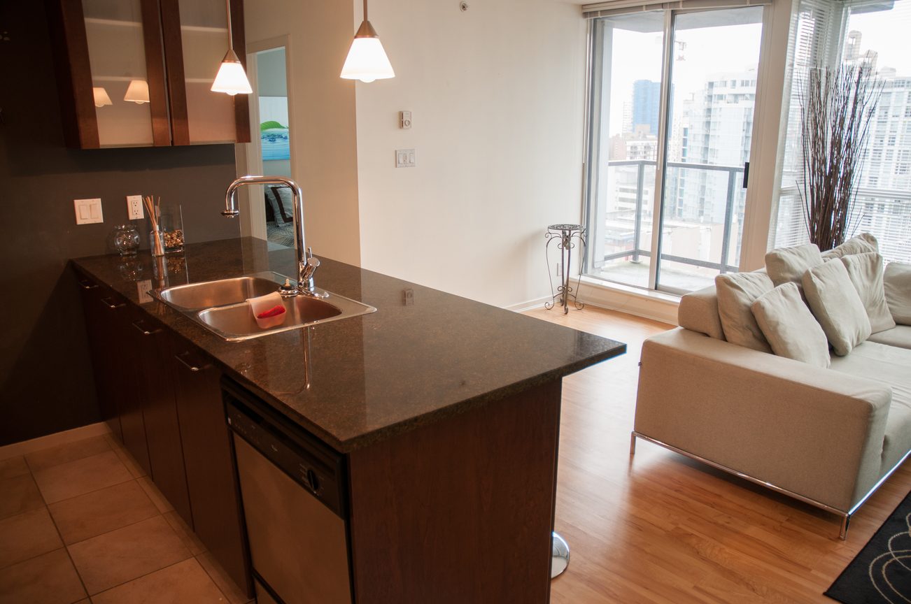 Bright kitchen with granite countertops, hardwood floors, and a city view. - 1601-1199 Seymour Street, Vancouver Downtown