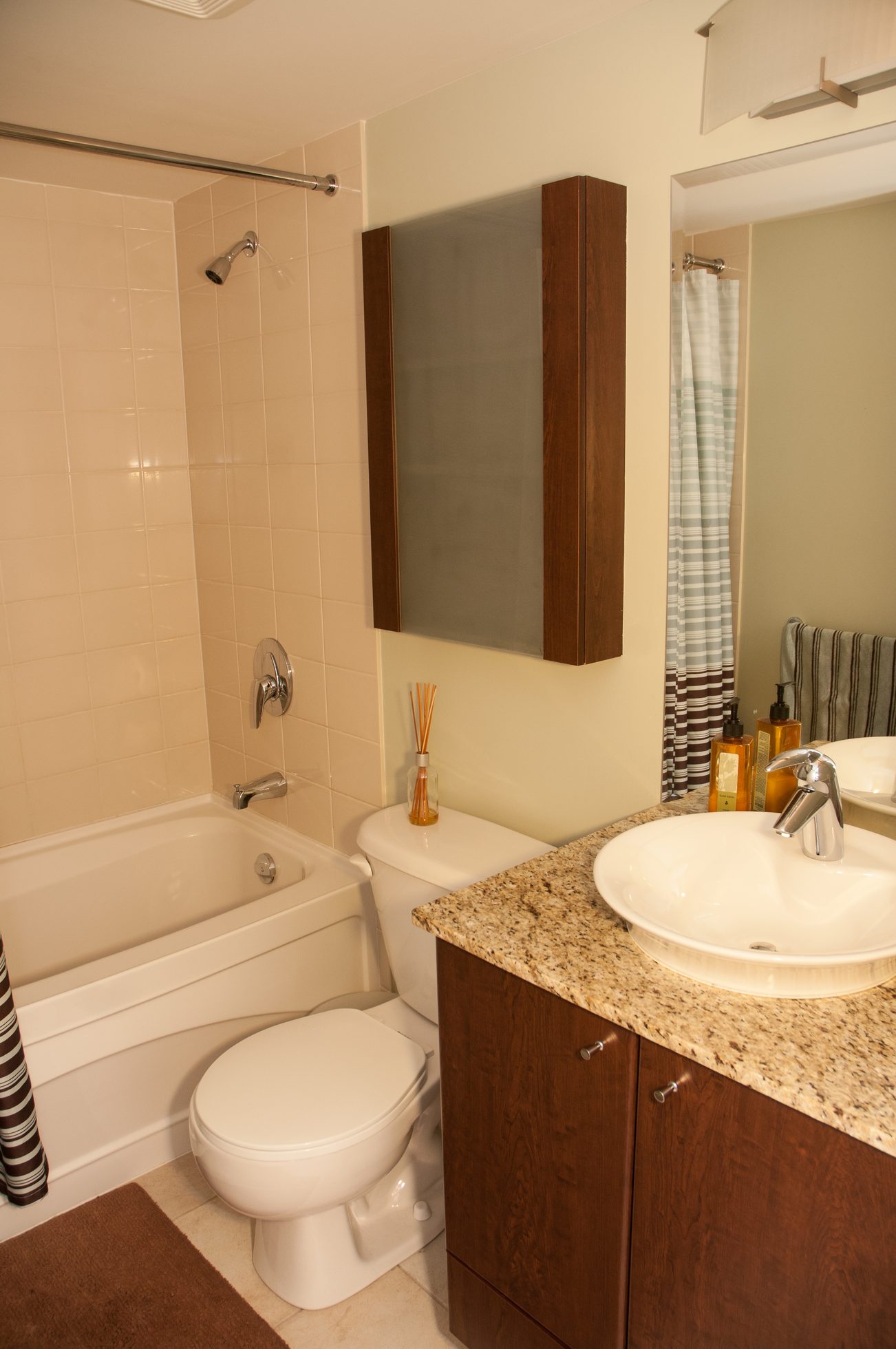 Furnished bathroom with granite countertop and wooden cabinet. - 1601-1199 Seymour Street, Vancouver Downtown