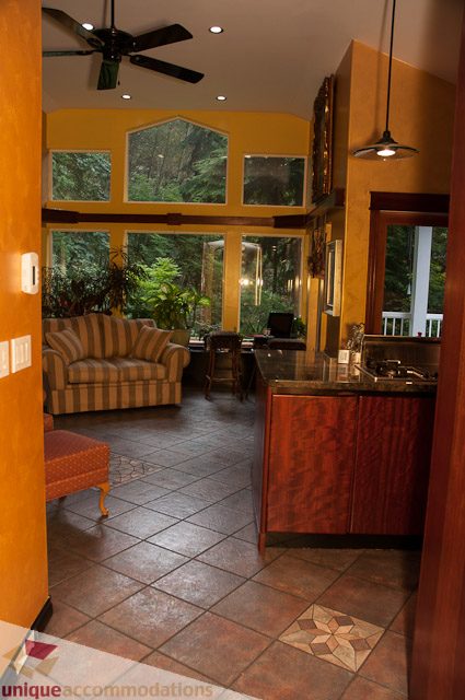 Bright kitchen with wooden cabinets, granite countertops, and a view of the garden. - 1650 Riverside Drive, North Vancouver