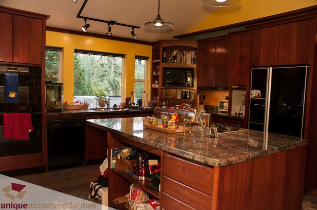 Bright kitchen with granite countertops, hardwood floors, and a city view. - 1650 Riverside Drive, North Vancouver