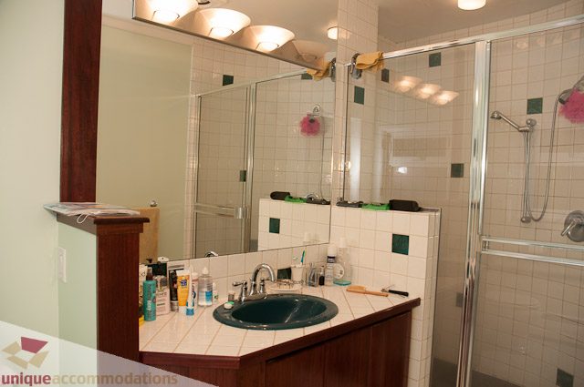 Furnished bathroom with white tiles, modern fixtures, and a glass shower. - 1650 Riverside Drive, North Vancouver