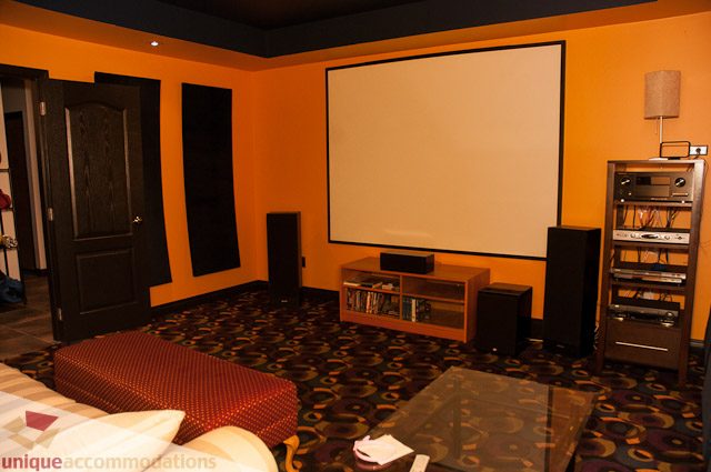 Home theater with large screen, surround sound, and plush seating. - 1650 Riverside Drive, North Vancouver