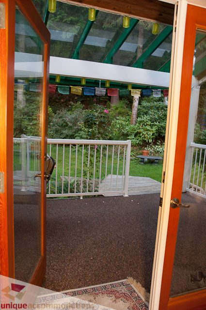 Furnished patio with colorful flags and garden view. - 1650 Riverside Drive, North Vancouver