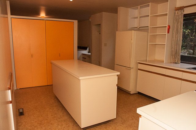 Modern kitchen with light wood cabinets and a large island. - 2919 Mathers Ave, West Vancouver
