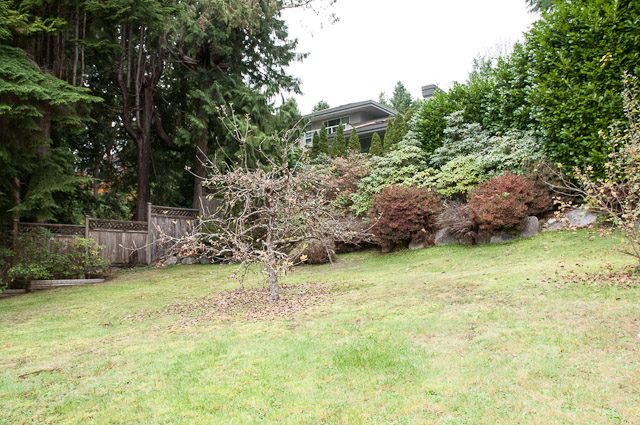 Lush garden with mature trees and shrubs, leading to a house. - 2919 Mathers Ave, West Vancouver