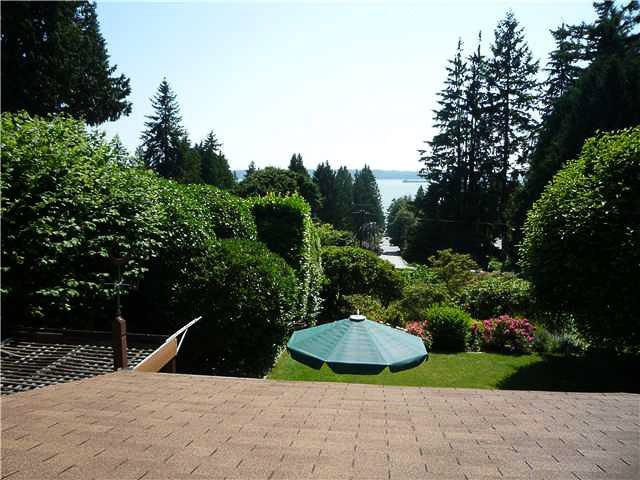 Furnished living room with a view of the water and lush greenery. - 2919 Mathers Ave, West Vancouver