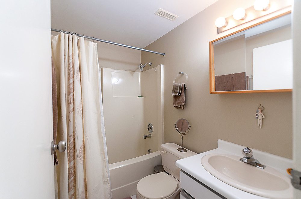 Bright bathroom with white countertop and beige walls. - 1119 Keith Road, West Vancouver