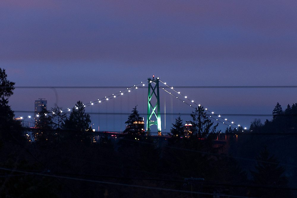 Furnished living room with city view and twinkling lights. - 1119 Keith Road, West Vancouver