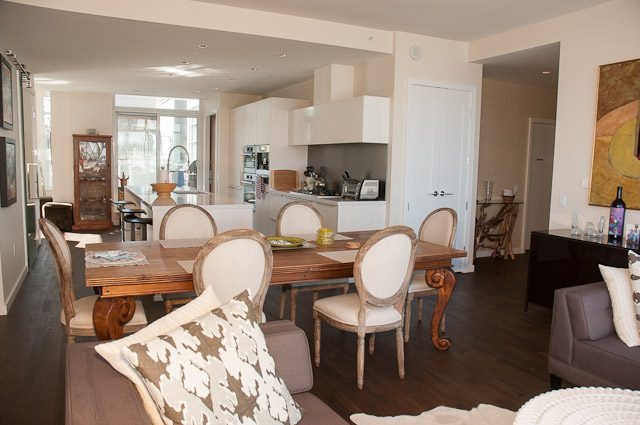 Furnished dining area with hardwood floors and modern decor. - 501-150 Athletes Way, Vancouver West Side
