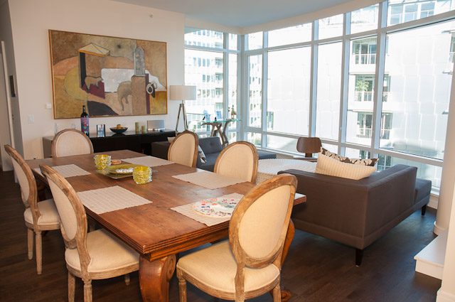 Bright dining area with large windows, hardwood floors, and a city view. - 501-150 Athletes Way, Vancouver West Side