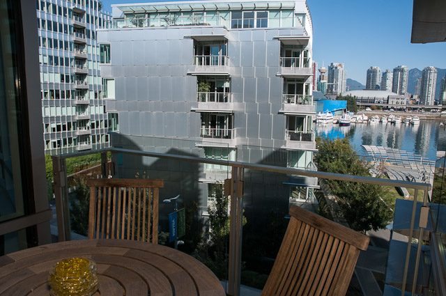 Spacious living room with city view and modern furnishings. - 501-150 Athletes Way, Vancouver West Side