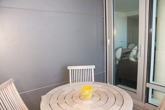 Furnished dining area with modern chairs and a unique table design. - 501-150 Athletes Way, Vancouver West Side