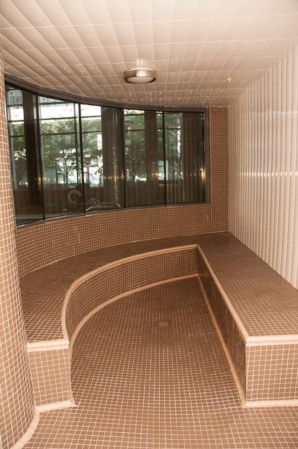 Spacious bathroom with curved bench and large windows. - 501-150 Athletes Way, Vancouver West Side