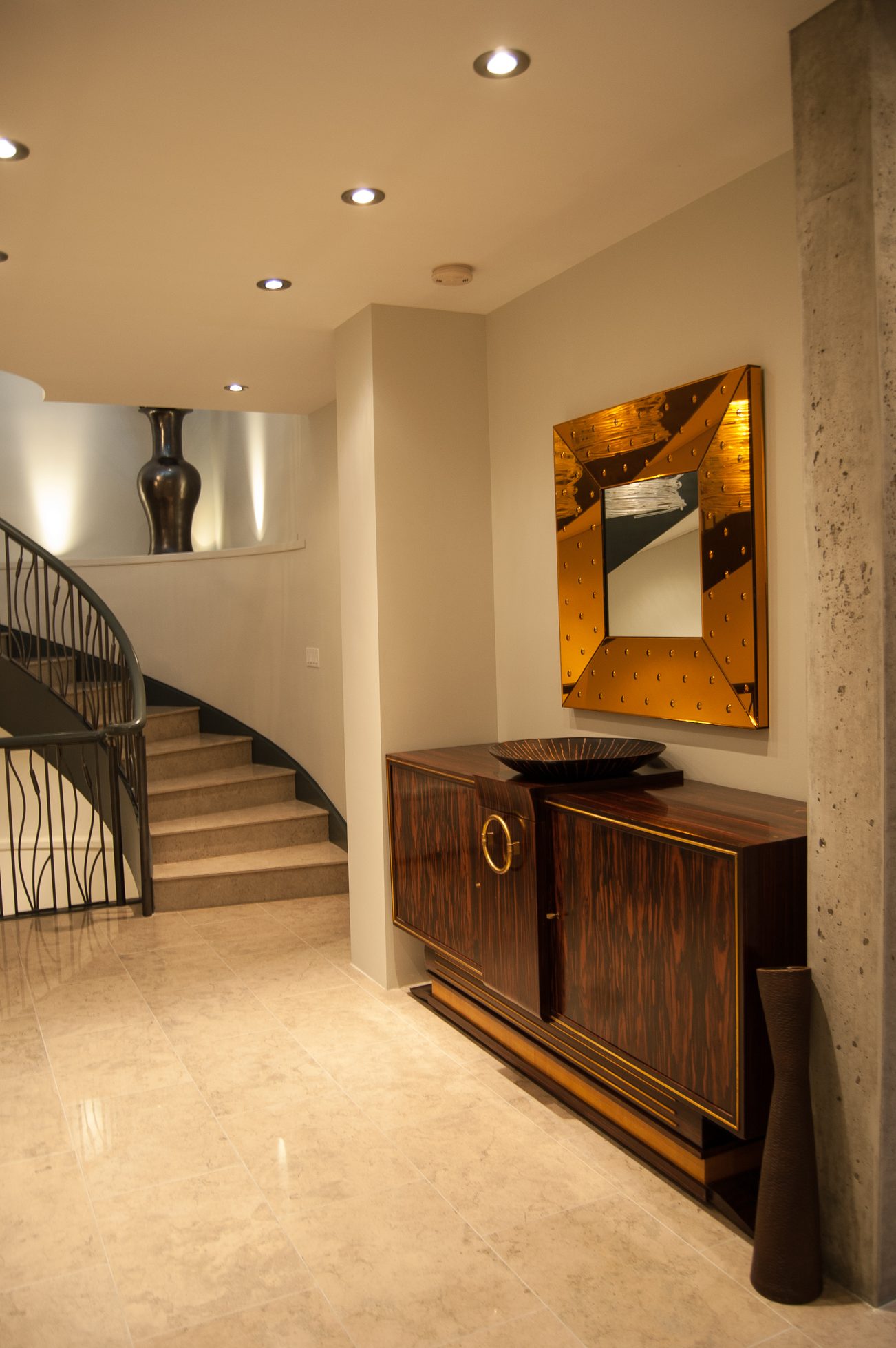 Foyer with marble floors, wooden cabinet, and modern mirror. - 4454 Regency Place, West Vancouver