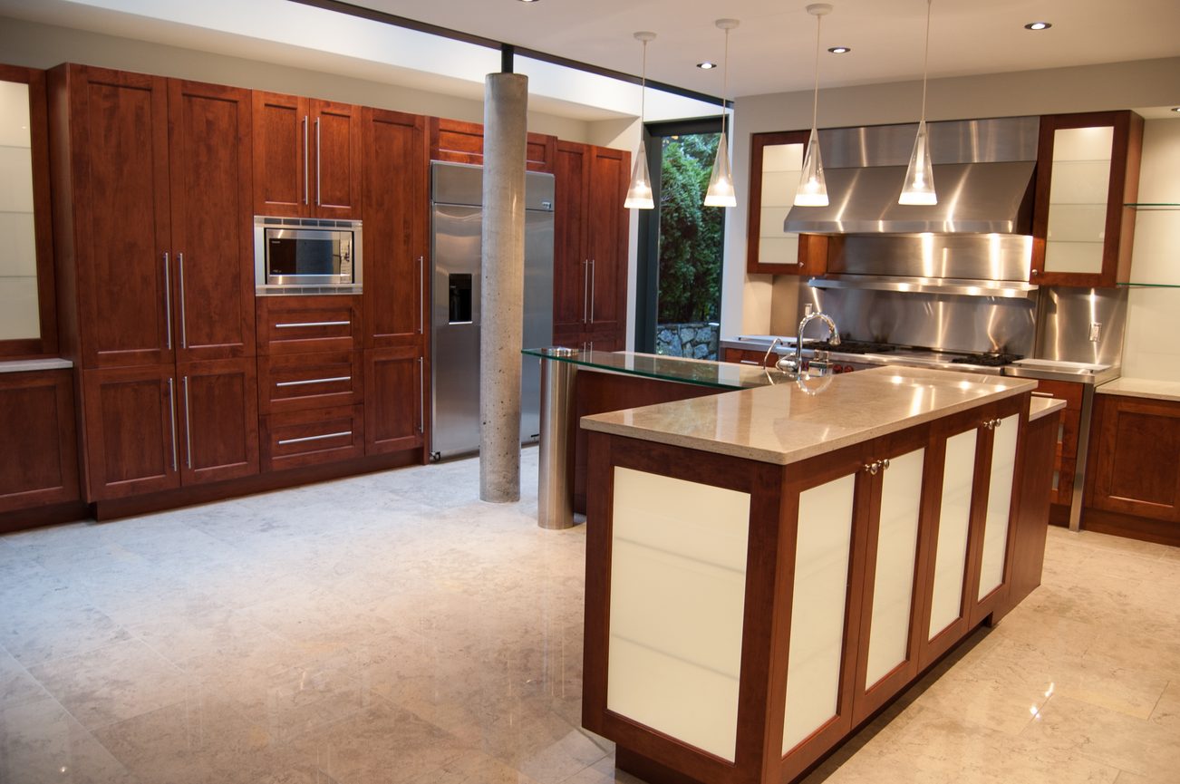 Bright kitchen with marble countertops, stainless steel appliances, and a large island. - 4454 Regency Place, West Vancouver