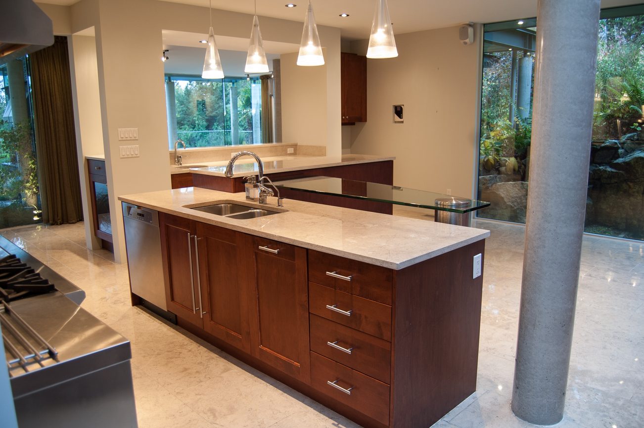 Bright kitchen with modern island, granite countertops, and large windows. - 4454 Regency Place, West Vancouver